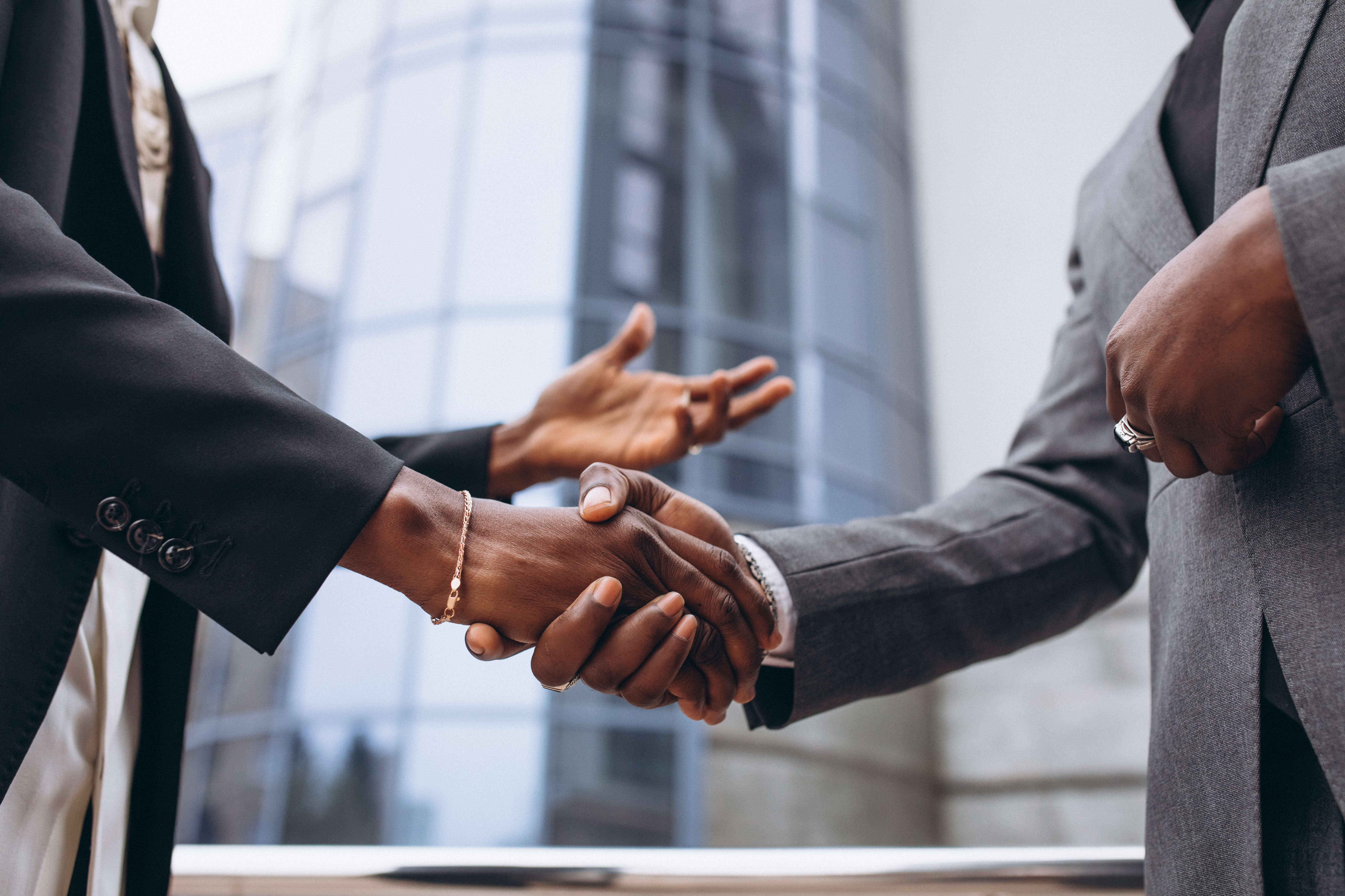 Business professionals shaking hands in a collaborative meeting
